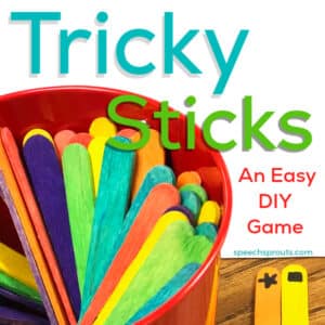 A DIY game for speech therapy. Colorful crafts sticks are inside a small red metal bucket. There are two sticks on the table with shapes drawn in marker at the top of the stick; one has a star, the other has a rectangle.
